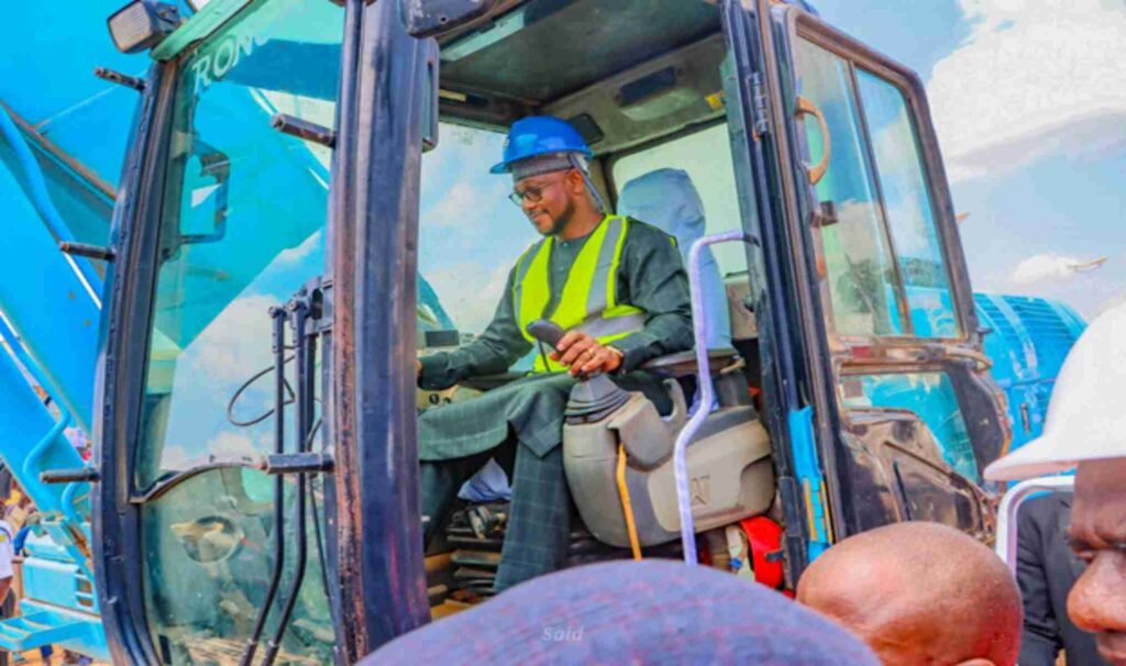 Gov. Dauda Lawal driving a tractor during a flag-off of an agricultural programme